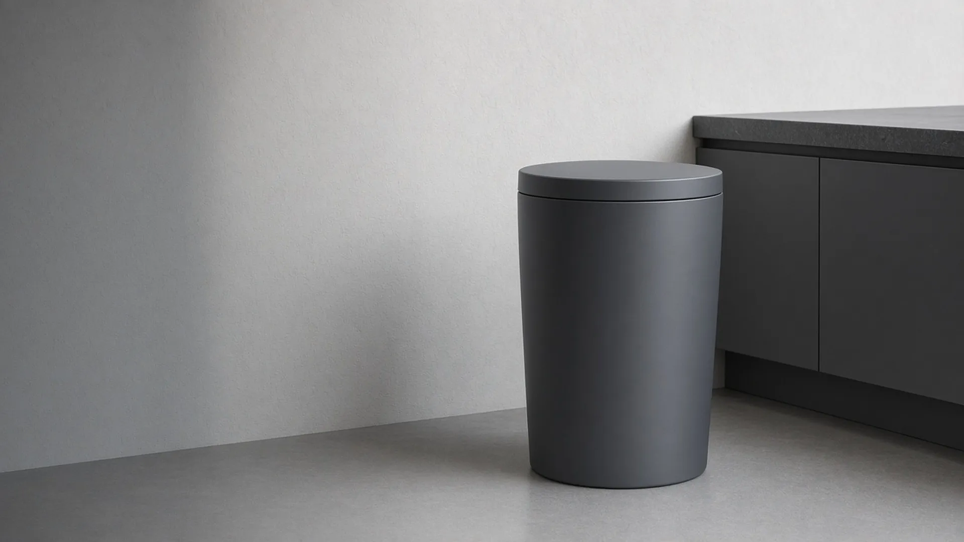 A matte charcoal touchless can in a modern kitchen