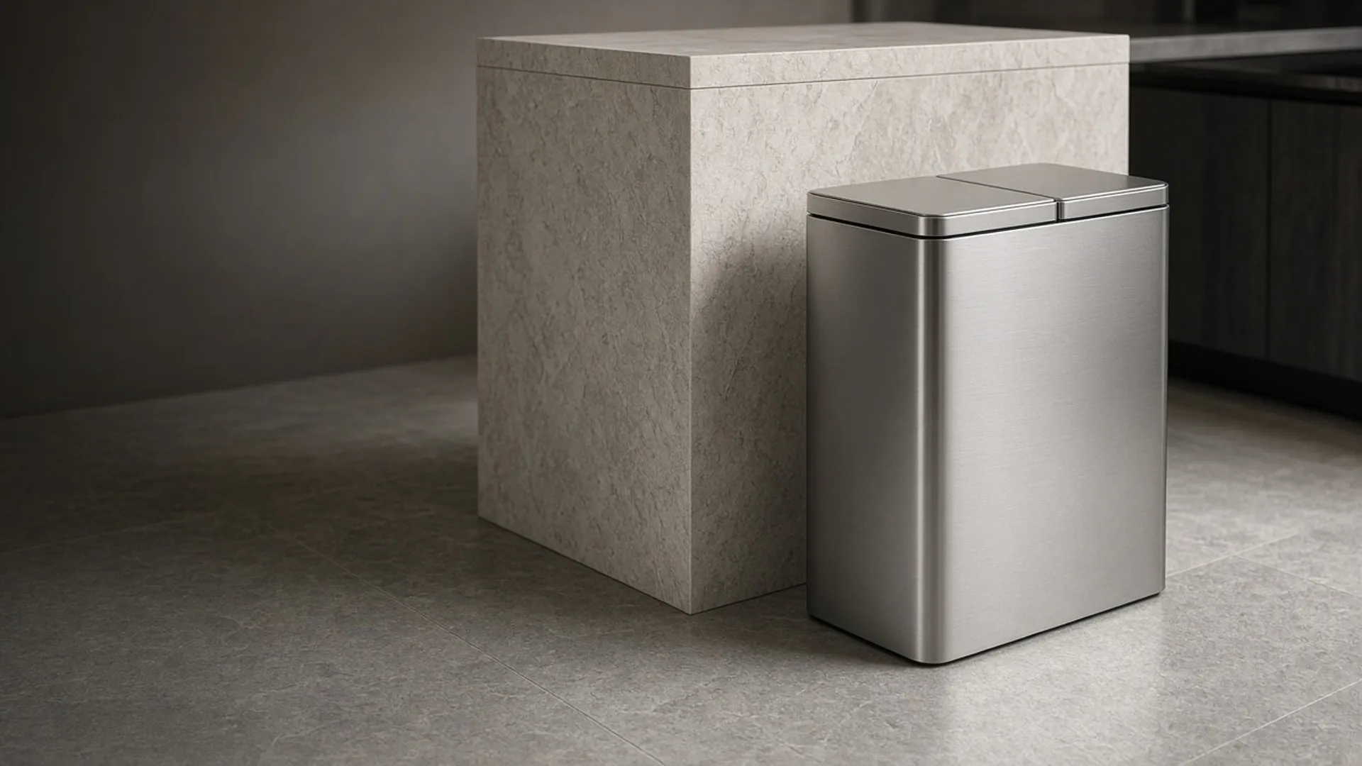 A dual-compartment trash can beside a kitchen island