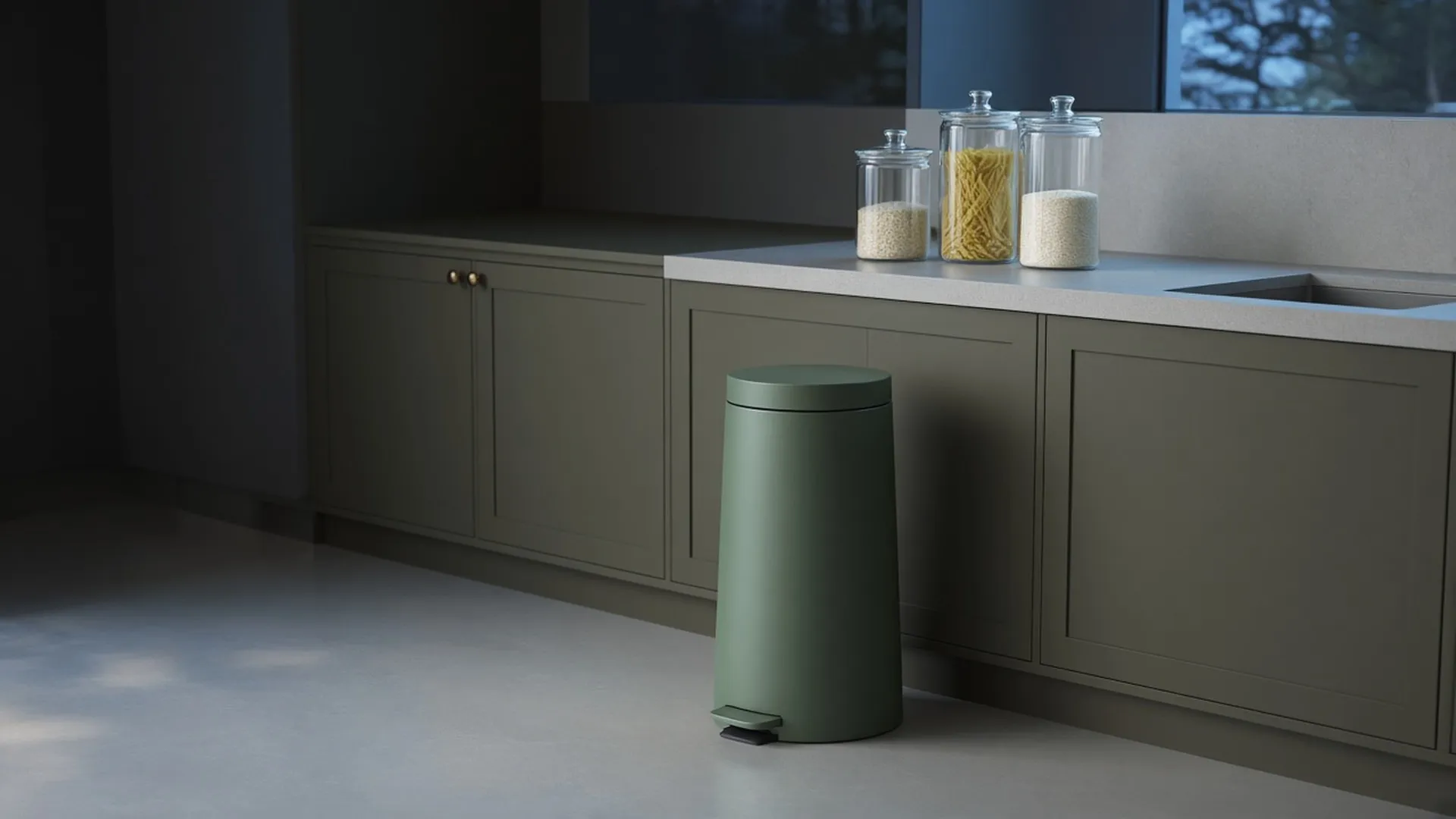 A closed trash can in a clean, uncluttered kitchen