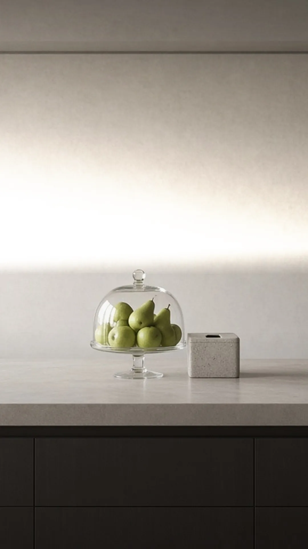 A covered fruit bowl and closed scrap caddy on a counter